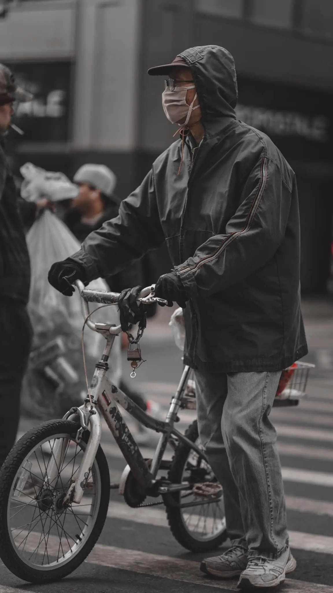 Children on bicycles in urban setting with monochromatic tones.