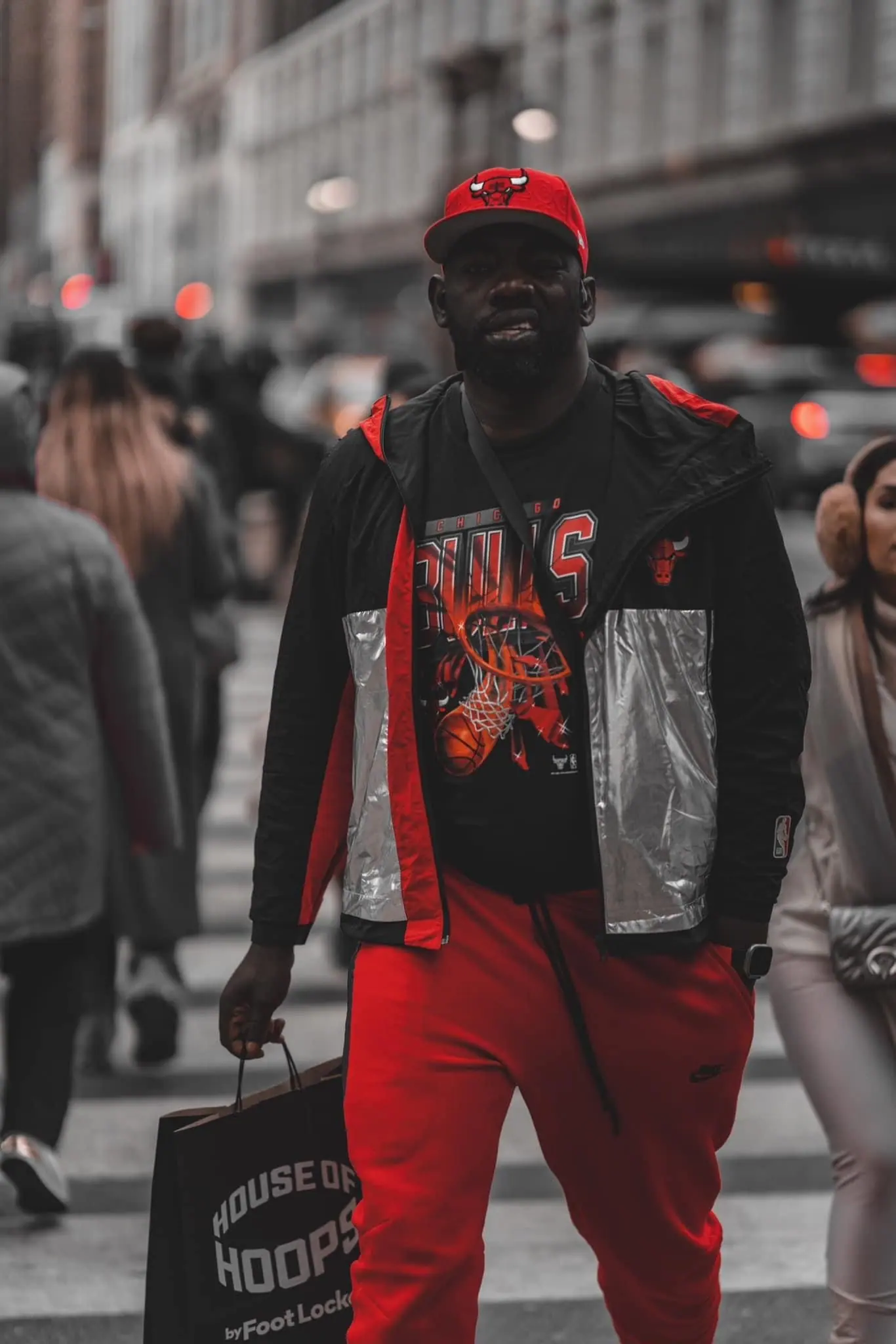 People walking on street wearing red and black urban streetwear clothing.