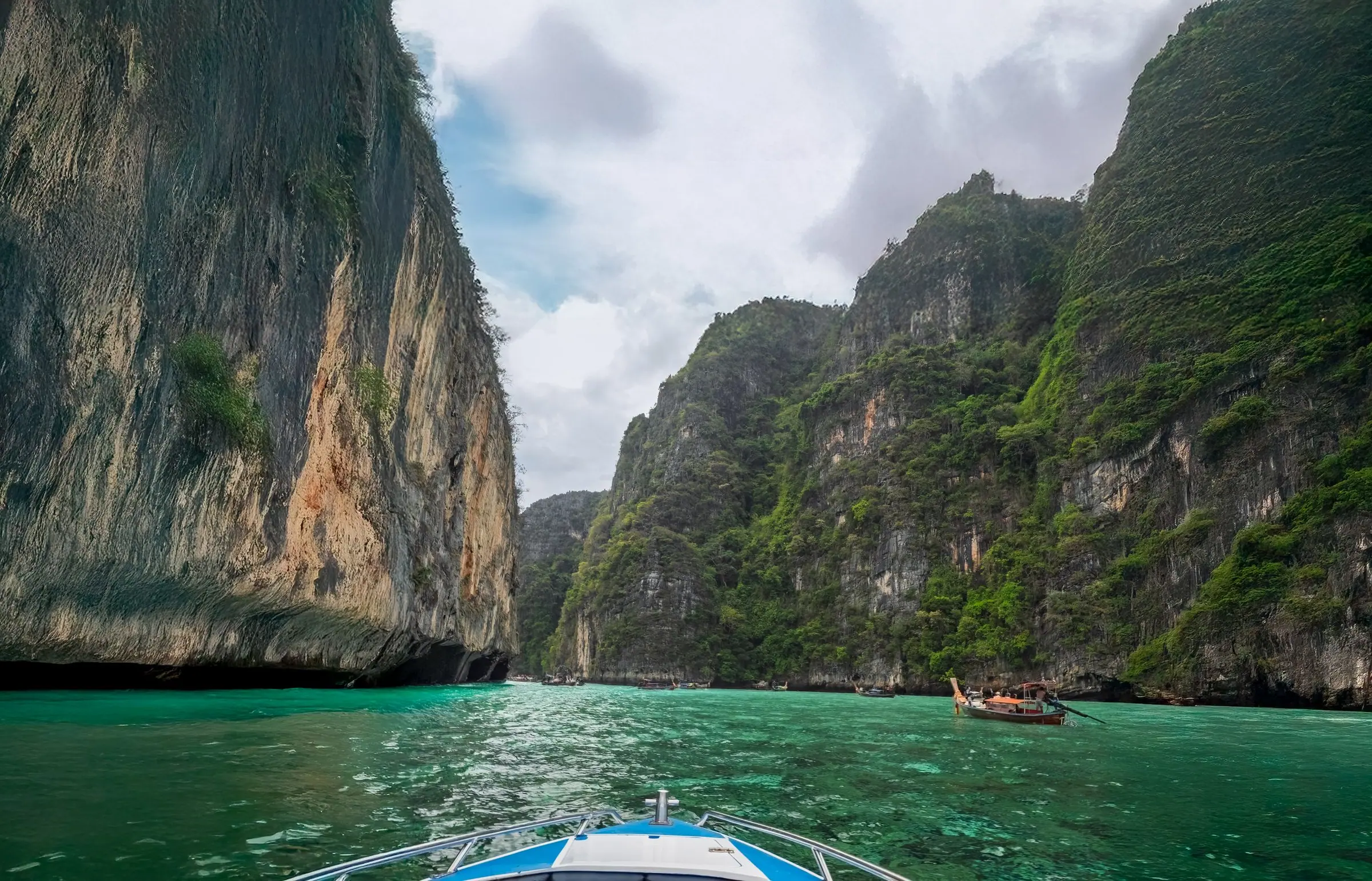 Stunning turquoise waters surrounded by towering limestone cliffs in a tropical lagoon.